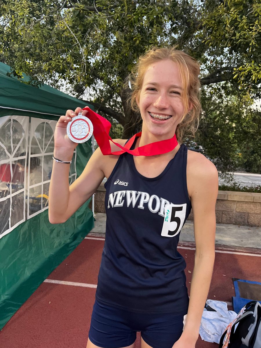 Newport Harbor track athlete holding a medal, from the Track 2023 album.